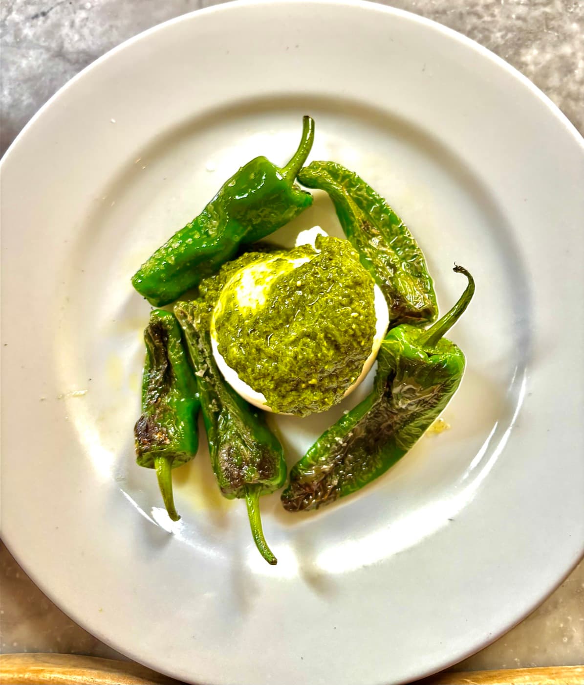 Creamy burrata with padron peppers and wild garlic pesto at Branca