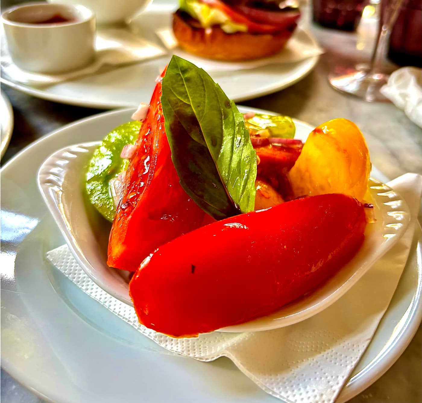 Heritage tomatoes with basil and balsamic glaze at Branca