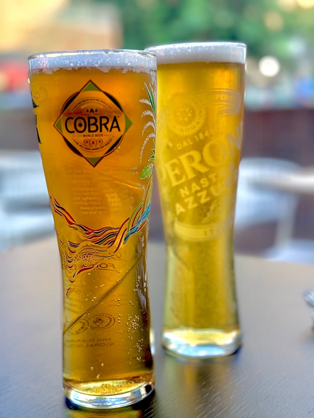 Two beers at Tempering, a Cobra and a Peroni, poured tall on the outdoor tables