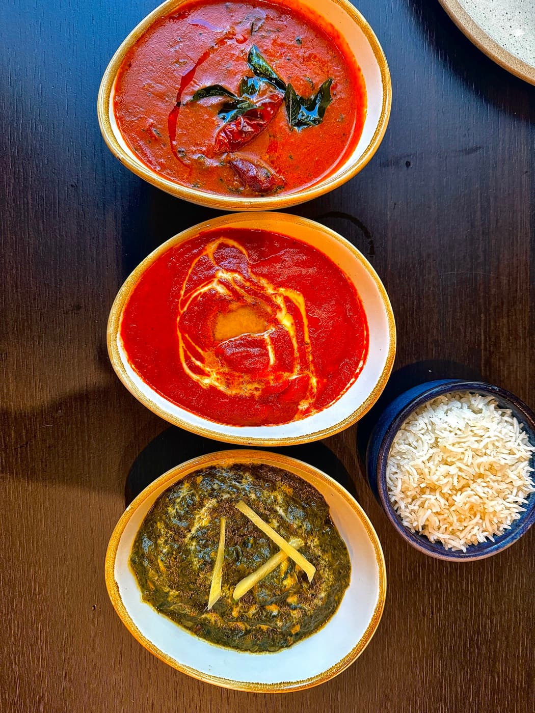 Three curries at Tempering (prawn gassi, butter chicken and palak paneer) with a bowl of basmati rice
